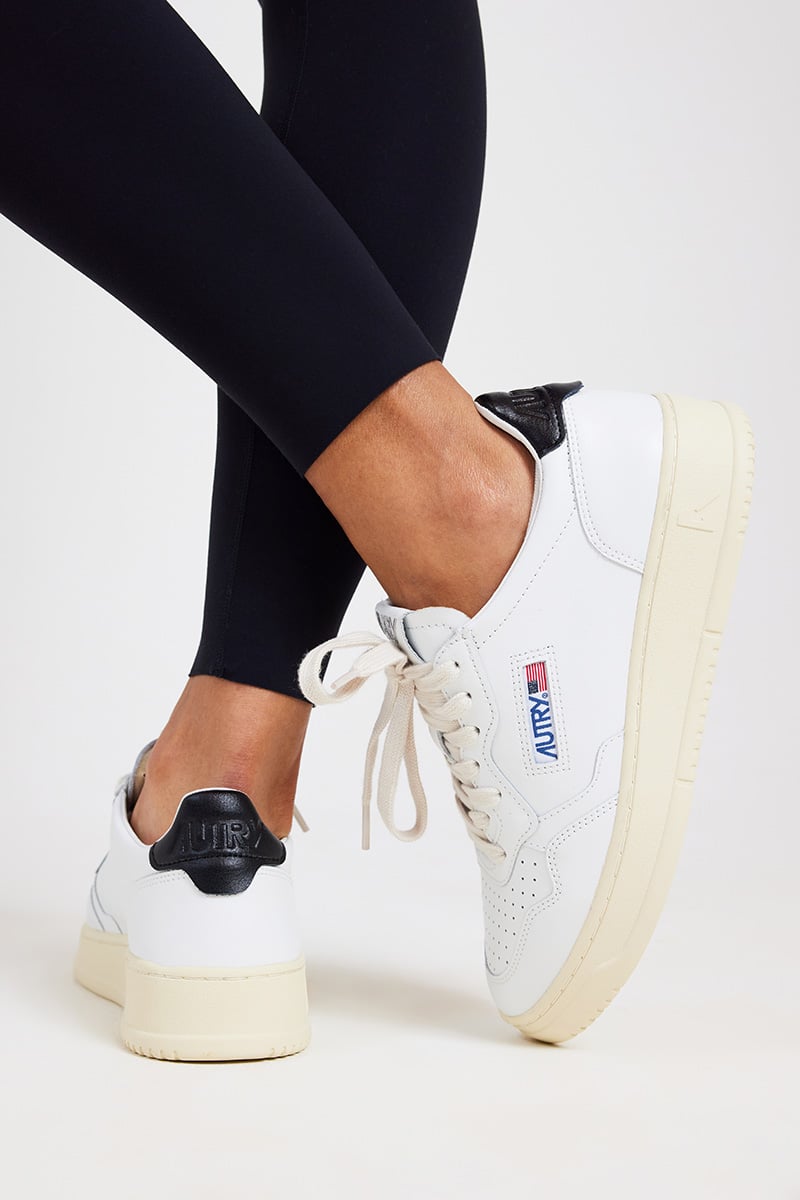 Girl In Black Leggings, Red Blouse And White Sneakers Stock Photo